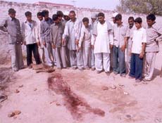 Villagers of Gulkani village show the blood marks