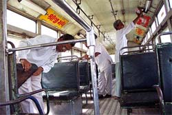 Workers of city bus services check before plying on their routes