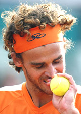 Gustavo Kuerten of Brazil reacts during his match 