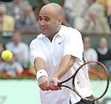 Andre Agassi of the USA returns a shot to David Sanchez