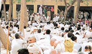 Women, with their faces covered, address a BKU rally in Kandela