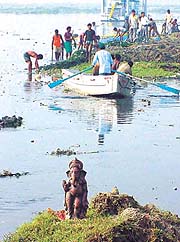 An idol of Ganapathi stands a mute witness to the Clean Yamuna Movement in the Capital.