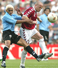 Denmarks Stig Tofting (R) challenges Uruguays Dario Silva in the first half of their group A match of the World Cup finals in Ulsan, South Korea, on Saturday.
