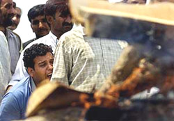 Gopal Sharma wails as he sees the burning pyre