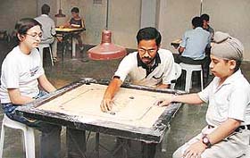 Arun Kedar gives tips on carrom to children at St. Stephens School, Sector 45, Chandigarh, on Monday.