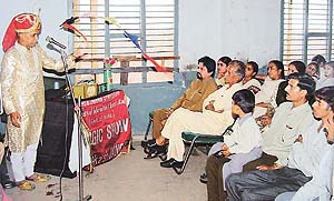 A magician speaks on AIDS awareness at Government Primary School in Burail village, Sector 45, Chandigarh, on Tuesday.