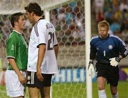 Germany's goalkeeper Oliver Kahn runs to calm his team mate