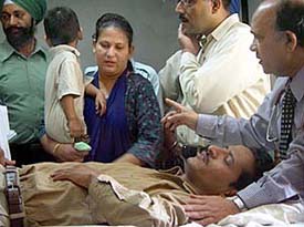 Pakistani Dr Qureshi and Indian Dr Rajinder examine the expelled staffer