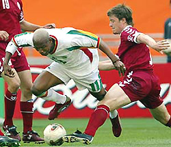Senegal's EI Hadji Diouf (L) and Denmark's Thomas Helveg fight for the ball during their group A World Cup finals match in Taegu on Thursday.