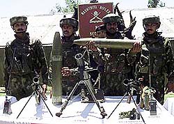 An Army jawan displays 107 mm rocket 