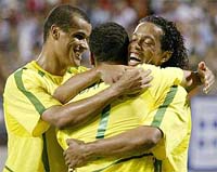 Brazilian Ronaldinho Gaucho jumps over his teammates to celebrate