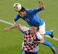 Italys Marco Materazzi outjumps Ivica Olic of Croatia