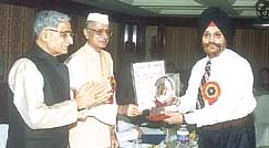 Mr S.S. Minhas, principal of GHPS, Vasant Vihar, being presented the Vijay Ratan Award by Dr Bhai Mahavir, Governor of Madhya Pradesh, in the Capital.