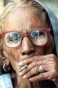 Sixty-five-year old Dharmo Devi smokes a 'bidi'