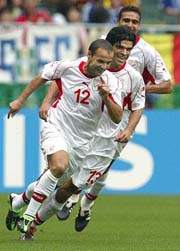 Tunisias Raouf Bouzaiene celebrates his goal against Belgium
