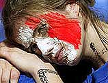 A supporter of France lays her head on her hands
