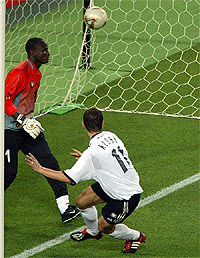 Germany's Miroslav Klose scores past Cameroon's goalkeeper 