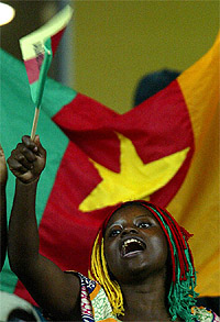 A Cameroon supporter waves the national flag 