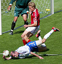 Frances Zinedine Zidane falls in front of Denmarks Martin Laursen 