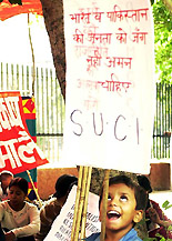 A young boy holds a placard 