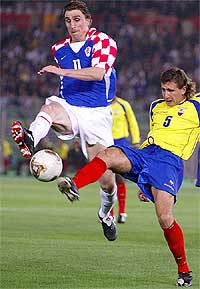 Croatia's Alen Boksic tussles with Ecuador's Alfonso Obregon