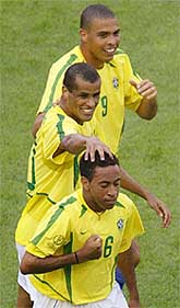 Brazils Junior  is congratulated by team-mates Rivaldo and Ronaldo