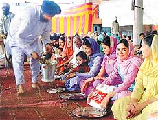 Devotees partake food at a langar