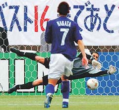 Tunisias goalkeeper Ali Boumnijel makes a save
