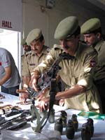 Policemen display arms and ammunition
