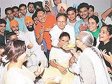 The PU Vice-Chancellor, Prof K.N. Pathak, offers juice to protesting students 