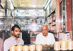 Shiv Narayan Pandey (right) with his son Hanuman at his shop