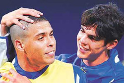 Brazils midfielder Kaka (R) jokes with the new hair cut of striker Ronaldo during their training session at Saitama Stadium on Monday.