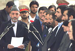 New Afghan President Hamid Karzai (L) inaugurates his cabinet at the Presidential Palace in Kabul on Monday.