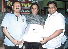 Board of Control for Cricket in India  senior vice-president C K Khanna  being given a memento 