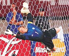 Germanys goalkeeper Oliver Kahn makes a diving save on a shot by South Koreas Lee Chun-soo 