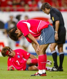 South Koreas Choi Jin-Cheul (C) reacts after his team missed a scoring opportunity against Germany while Swiss referee Urs Meier (R) checks on Kim Tae-young during their semifinal in Seoul on Wednesday. 