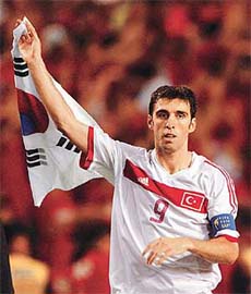 Turkeys Hakan Sukur waves the South Korea flag 