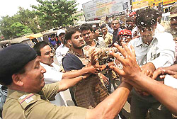 The police tries to snatch a bottle of petrol