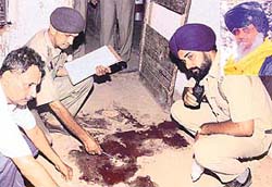 Policemen examine the spot where Pal Singh Pala (inset) was shot