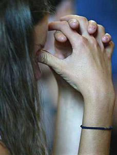 A young unidentified German girl mourns during a religious ceremony