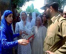A police official listens to one of the protesters