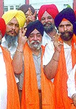 Parmjit Singh Sarna, showing the victory sign.