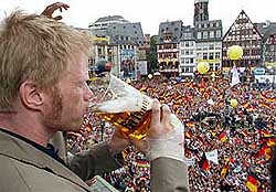 Germanys goalkeeper Oliver Kahn drinks beer on a balcony
