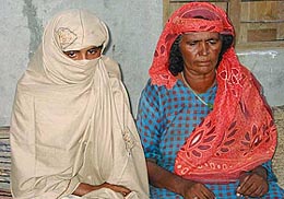 The Pakistani teenaged girl, who was ordered to be gangraped by tribal village elders, sits with her mother at Meerwala Jatoi village, near Multan