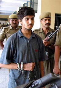 Handcuffed Zulfikar Ali is presented before newsmen