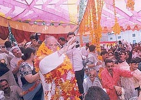 Mr Sukh Ram waves to the crowd during a procession