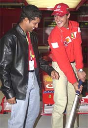 German F1 Ferrari Driver Micheal Schumacher (right) gets a cricket lesson from Indian batsman Sachin Tendulkar 