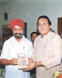 The president of the Hotel and Restaurant Association, Punjab, Mr N.S. Nanda, presents a copy of the Punjab guide to the Union Minister of State for Tourism, Mr Vinod Khanna
