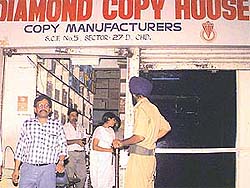Sleuths of the Income Tax Department carry out survey at Diamond Copy House in Sector 27 in Chandigarh on Thursday.