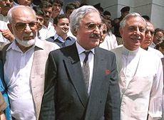Pakistan Muslim League (PML-Q) leader Iftikhar Gilani flanked by other party leaders Gohar Ayub Khan and Majeed Malik, speaks to journalists outside the Supreme Court in Islamabad